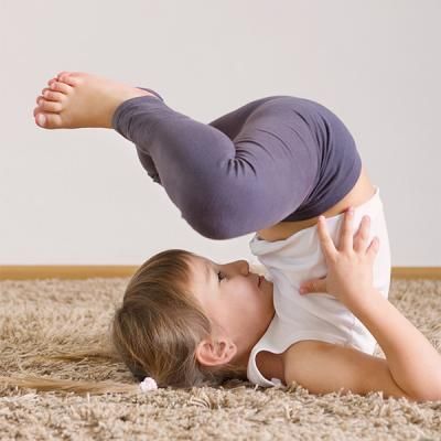 A young child doing yoga.