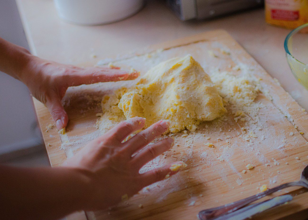 hands making dough for baking