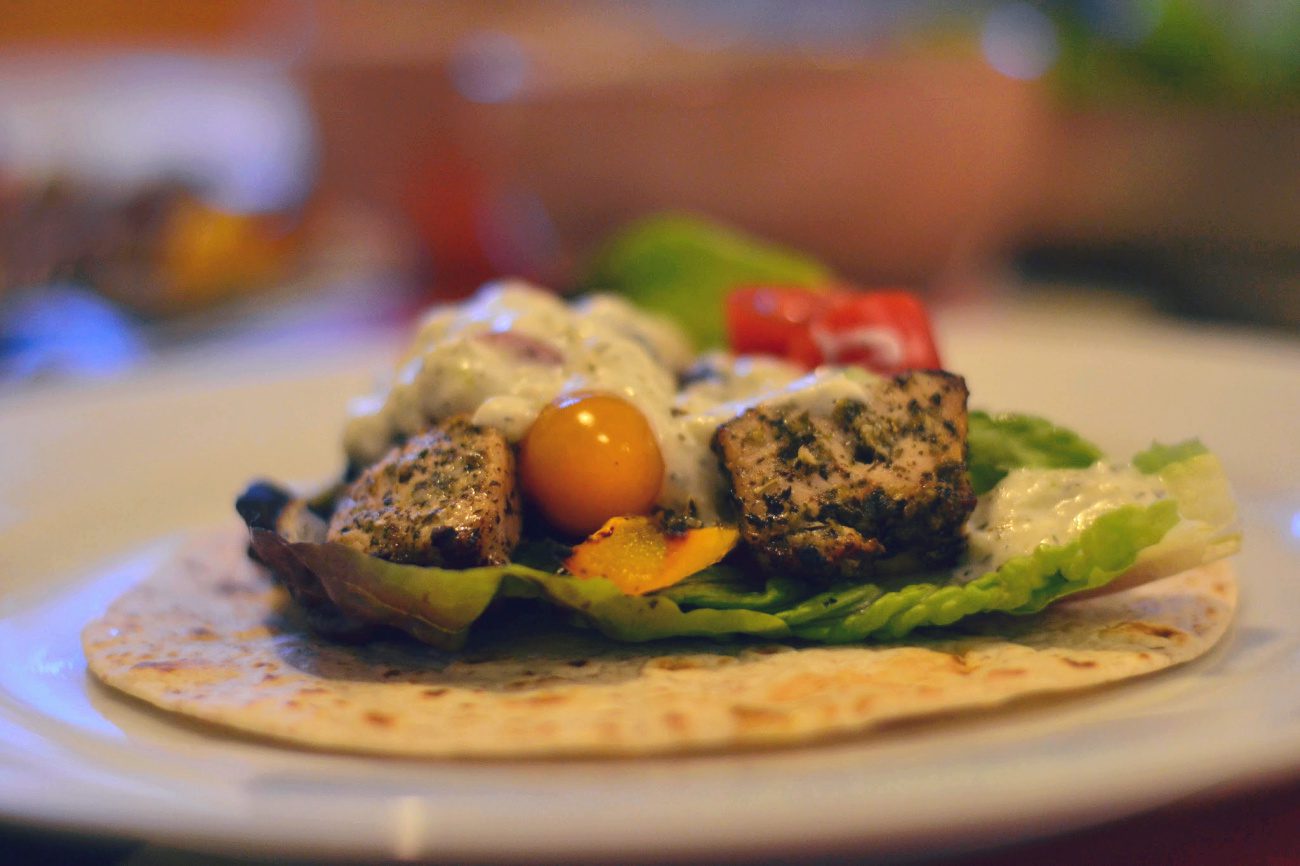 greek-style kebabs with salad and dip on a wrap