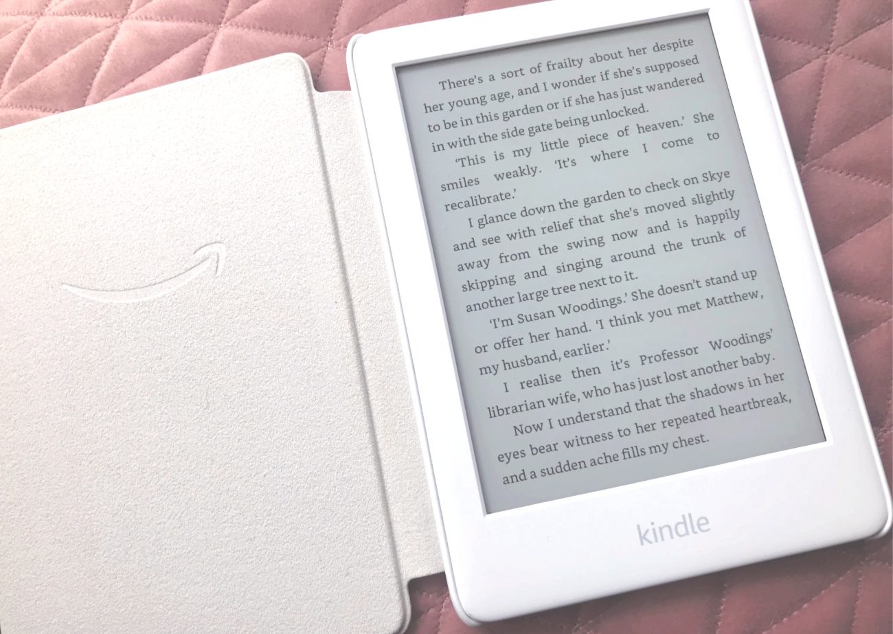 white Kindle in white cover on pink material