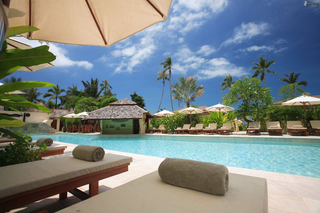pool area with loungers next to it