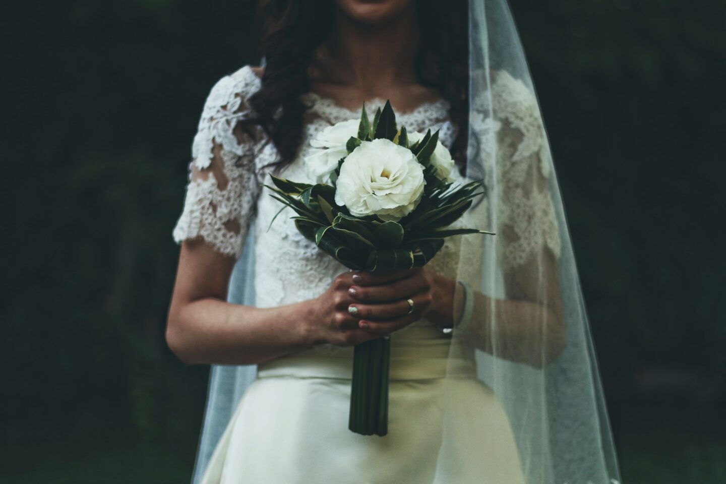 bride up close holding white flowers