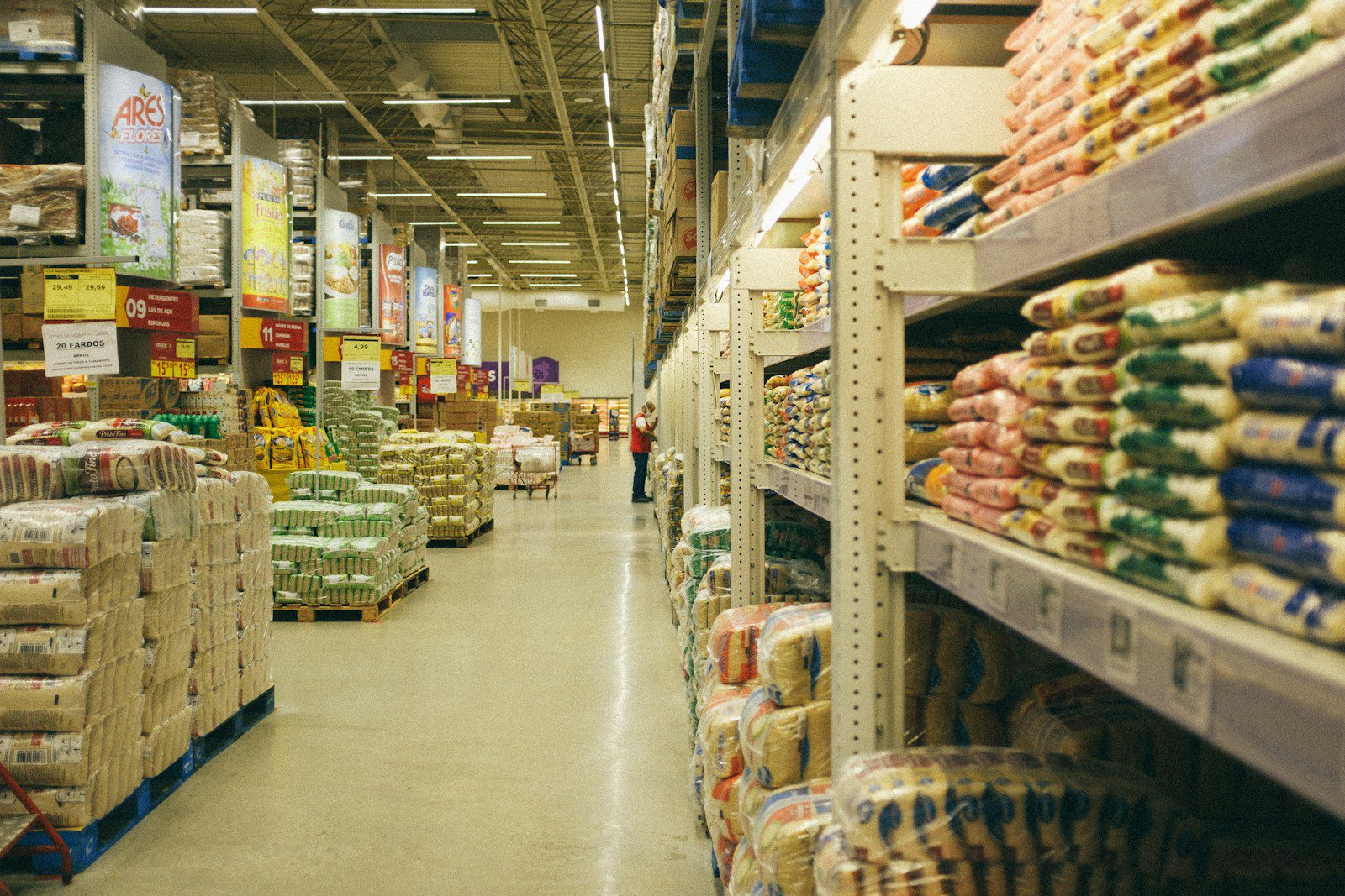 white metal shelves with food in shopping warehouse