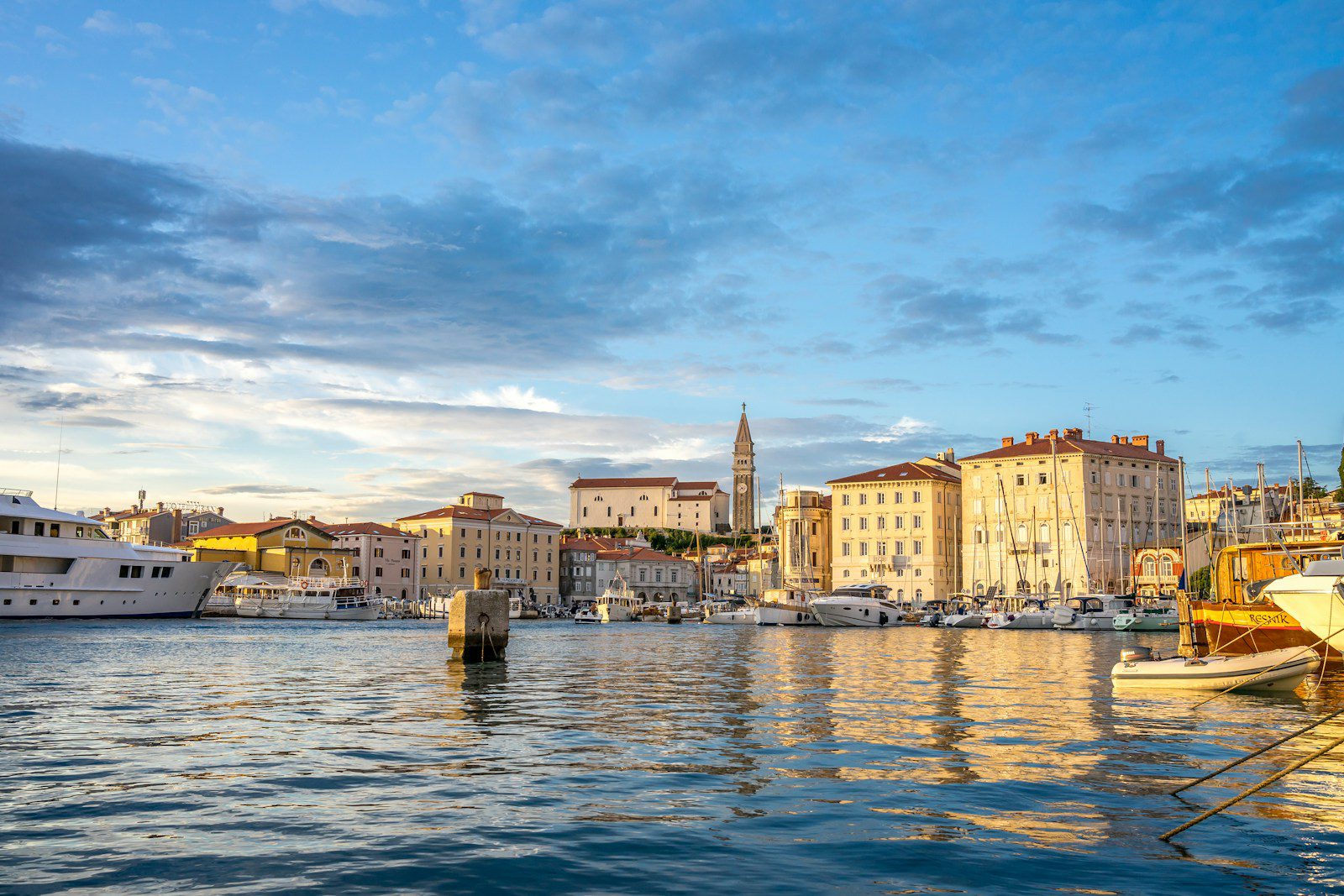 a harbor filled with lots of boats next to tall buildings in Istria