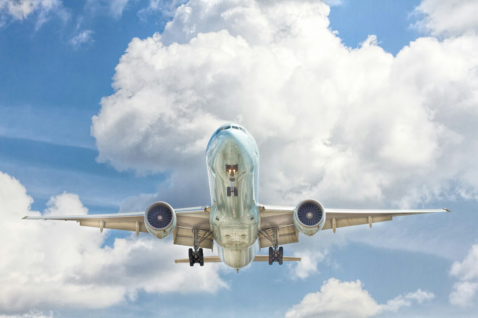 aeroplane on flight near blue sky with white clouds